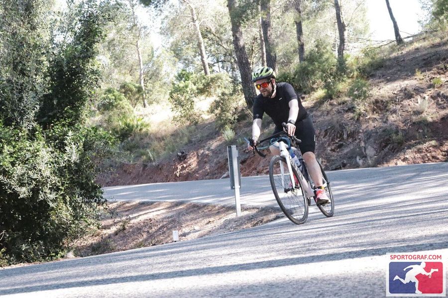 Jamie riding through pine forest on the Valencia climb