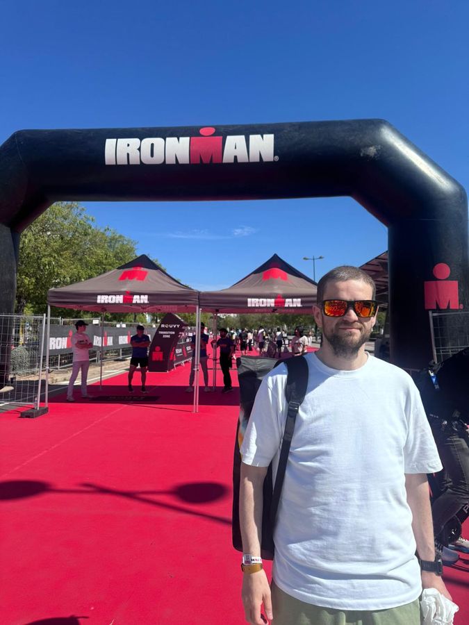 Jamie at the transition zone entrance under the IRONMAN arch